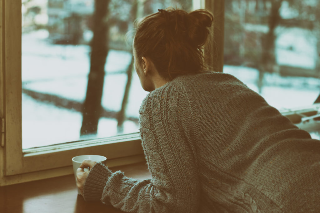 Woman looking out window